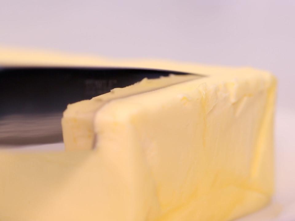 knife slicing through a stick of butter