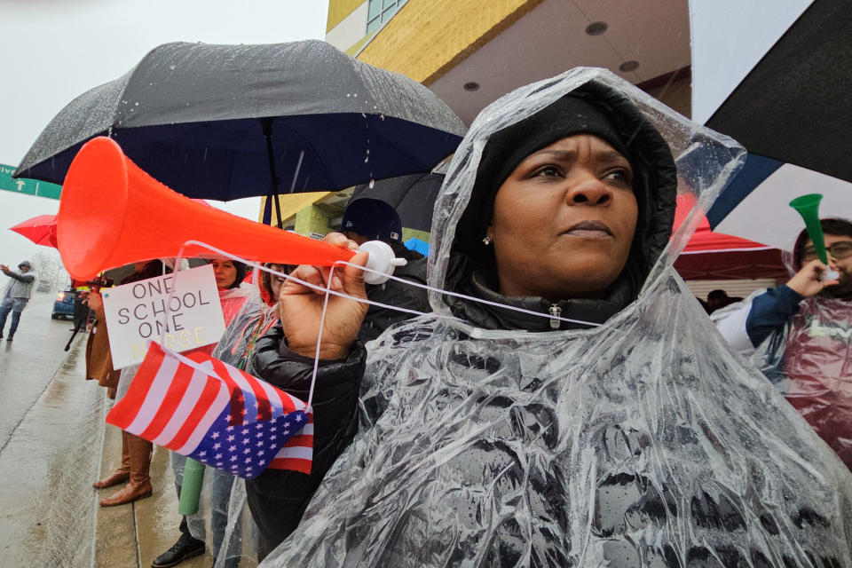 Los Angeles Unified School District teachers and Service Employees International Union 99 (SEIU) members rally under heavy rain outside the Edward R. Roybal Learning Center in Los Angeles, Tuesday, March 21, 2023. Tens of thousands of workers in the Los Angeles Unified School District walked off the job Tuesday over stalled contract talks, and they were joined by teachers in a three-day strike that shut down the nation’s second-largest school system. (AP Photo/Damian Dovarganes)