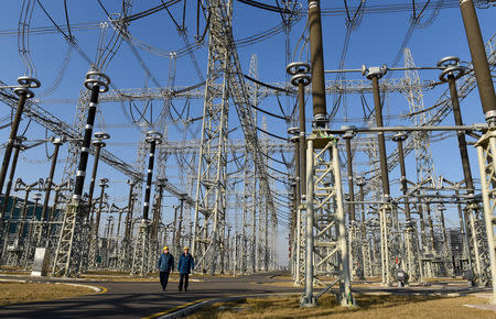 Workers inspect an electrical substation in Linyi, Shandong province, China January 17, 2019. Picture taken January 17, 2019. REUTERS/Stringer