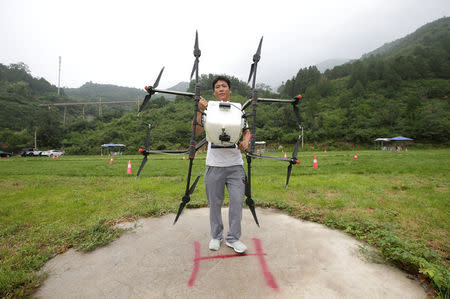 A trainee holds an aerosol drone for calibration preparation before he learns to fly it at LTFY drone training school on the outskirts of Beijing, China August 2, 2017. Picture taken August 2, 2017. REUTERS/Jason Lee