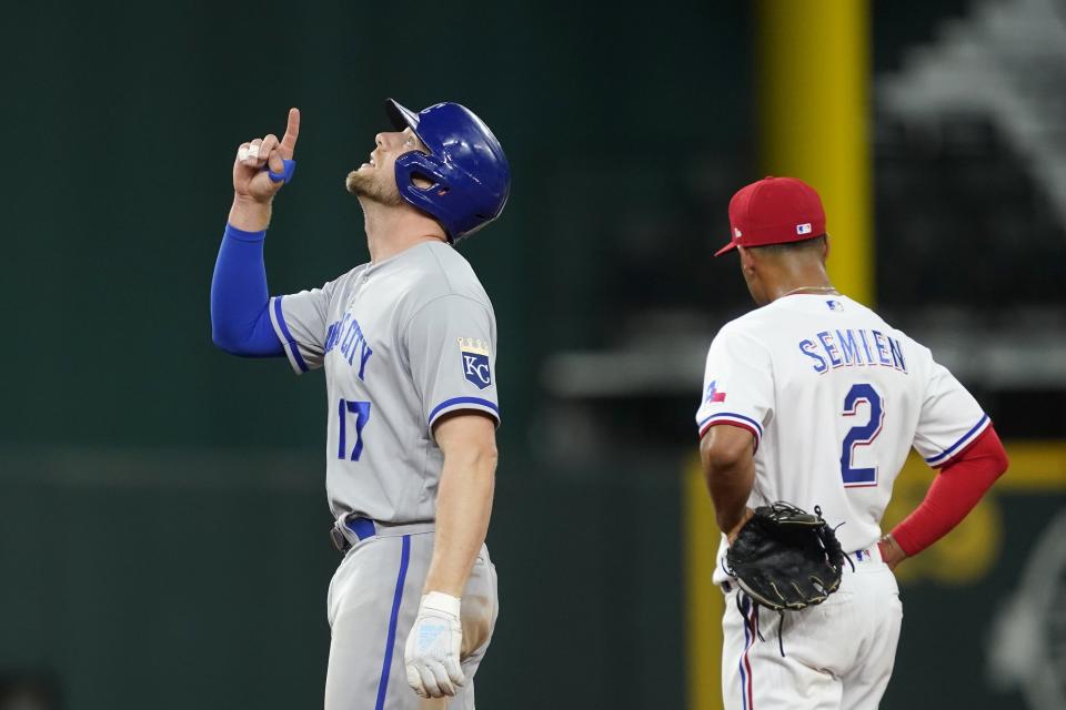 Kansas City Royals' Hunter Dozier (17) celebrates his double as Texas Rangers second baseman Marcus Semien stands by in the fifth inning of a baseball game, Tuesday, May 10, 2022, in Arlington, Texas. (AP Photo/Tony Gutierrez)