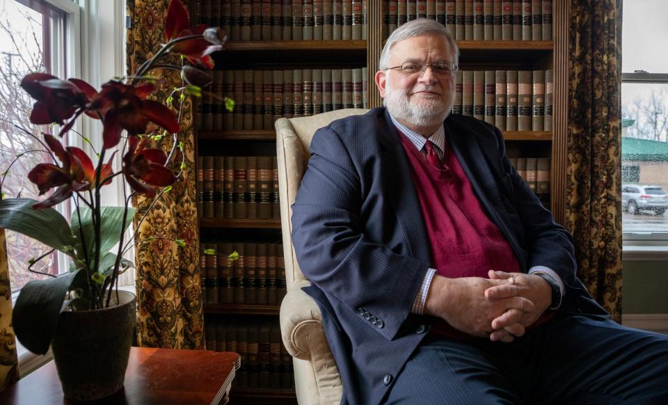 David Kallman, 67, an attorney based in Lansing, sits on a chair inside the library room at Kallman Legal Group, his general practice law firm.