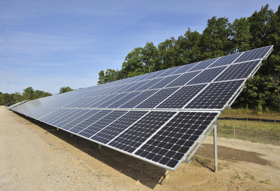 FILE - One of more than 4,000 solar panels constructed by DTE Energy lines a 9.37-acre swath of land in Ann Arbor Township, Mich., Sept. 15, 2015. Michigan will join four other states in requiring utility providers to transition to 100% carbon-free energy generation by 2040 under legislation that will soon be signed by Gov. Gretchen Whitmer. (Ryan Stanton/Ann Arbor News via AP, File)