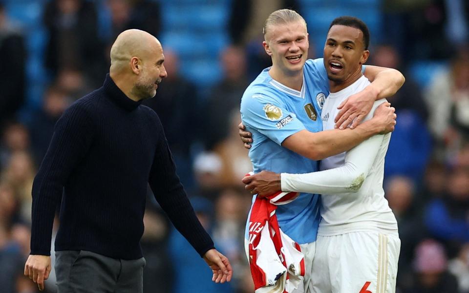 Manchester City manager Pep Guardiola and Erling Braut Haaland with Arsenal's Gabriel after the match