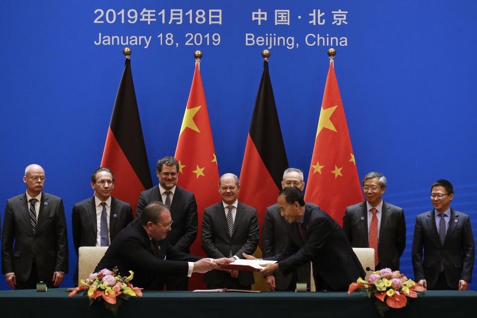 German Finance Minister Olaf Scholz, center, and Chinese Vice Premier Liu He, third right in the back, witness a signing ceremony after the China-Germany High Level Financial Dialogue at the Diaoyutai State Guesthouse in Beijing, Friday, Jan. 18, 2019. (AP Photo/Andy Wong, Pool)