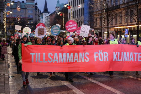 Climate change protestors carry a banner that reads "Together for the Climate" as they march during a demonstration in Stockholm, Sweden, November 29, 2015, ahead of the World Climate Change Conference 2015 (COP21) in France. REUTERS/Christine Olsson/TT News Agency