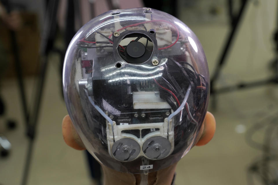 The head of Sophia shows the inside content visually through the transparent skull at Hanson Robotics studio in Hong Kong on March 29, 2021. Sophia is a robot of many talents — she speaks, jokes, sings and even makes art. In March, she caused a stir in the art world when a digital work she created as part of a collaboration was sold at an auction for $688,888 in the form of a non-fungible token (NFT). (AP Photo/Vincent Yu)