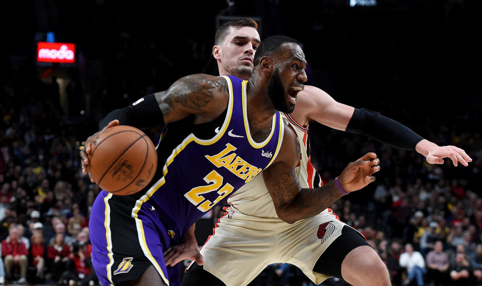 PORTLAND, OREGON - DECEMBER 06: LeBron James #23 of the Los Angeles Lakers drives to the basket on Mario Hezonja #44 of the Portland Trail Blazers during the second half of the game at Moda Center on December 06, 2019 in Portland, Oregon. The Lakers won 136-113. NOTE TO USER: User expressly acknowledges and agrees that, by downloading and or using this photograph, User is consenting to the terms and conditions of the Getty Images License Agreement. (Photo by Steve Dykes/Getty Images)