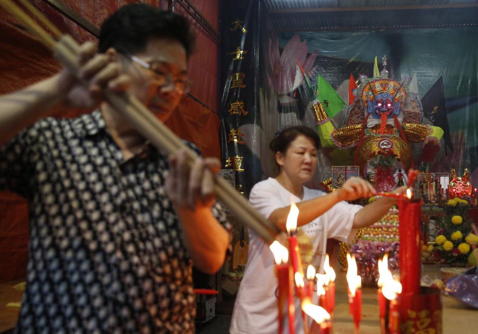 People light joss sticks during the Hungry Ghost festival in Kuala Lumpur