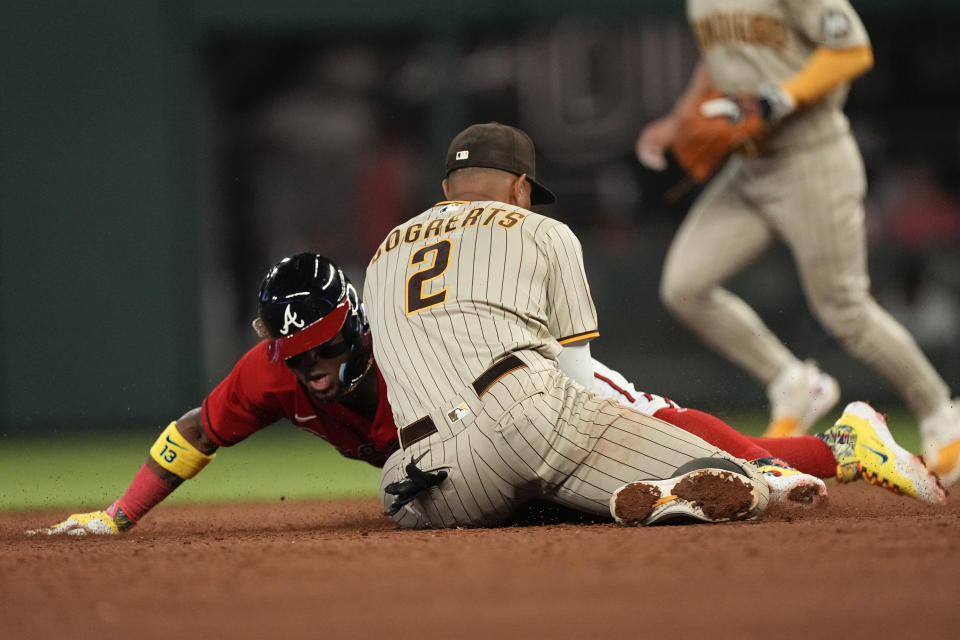 Atlanta Braves right fielder Ronald Acuna Jr., left, beats the tag by San Diego Padres shortstop Xander Bogaerts (2) to steal second base in the fifth inning of a baseball game, Friday, April 7, 2023, in Atlanta. (AP Photo/John Bazemore)