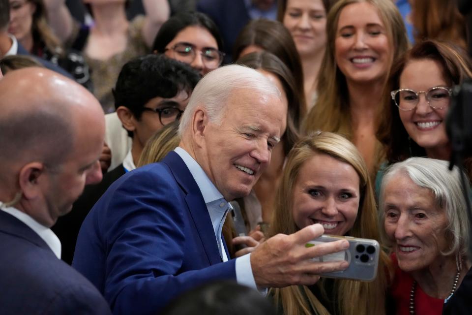 President Joe Biden takes a selfie with supporters in the audience after speaking at the Arcosa Wind Towers, Wednesday, Aug. 9, 2023, in Belen, N.M.