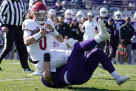 Northwestern defensive tackle Trevor Kent, bottom, tackles Rutgers quarterback Noah Vedral during the second half of an NCAA college football game in Evanston, Ill., Saturday, Oct. 16, 2021. Northwestern won 21-7. (AP Photo/Nam Y. Huh)