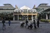 People walk in the near empty area of Covent Garden, in London, Tuesday, Nov. 24, 2020. Haircuts, shopping trips and visits to the pub will be back on the agenda for millions of people when a four-week lockdown in England comes to an end next week, British Prime Minister Boris Johnson said Monday. (AP Photo/Alberto Pezzali)