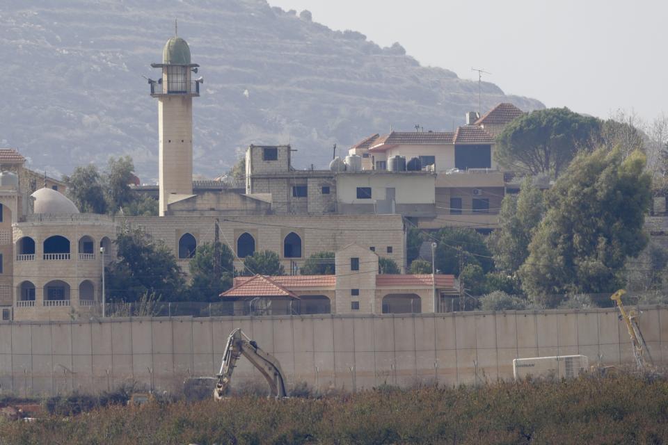 Israeli military digger works on the border with Lebanon in the northern Israeli town of Metula, Tuesday, Dec. 4, 2018. The Israeli military launched an operation on Tuesday to "expose and thwart" tunnels built by the Hezbollah militant group it says stretch from Lebanon into northern Israel. (AP Photo/Ariel Schalit)