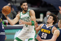 Boston Celtics forward Jayson Tatum, left, passes the ball as Denver Nuggets forward Aaron Gordon, center, and center Nikola Jokic, right, defend in the first half of an NBA basketball game Sunday, April 11, 2021, in Denver. (AP Photo/David Zalubowski)