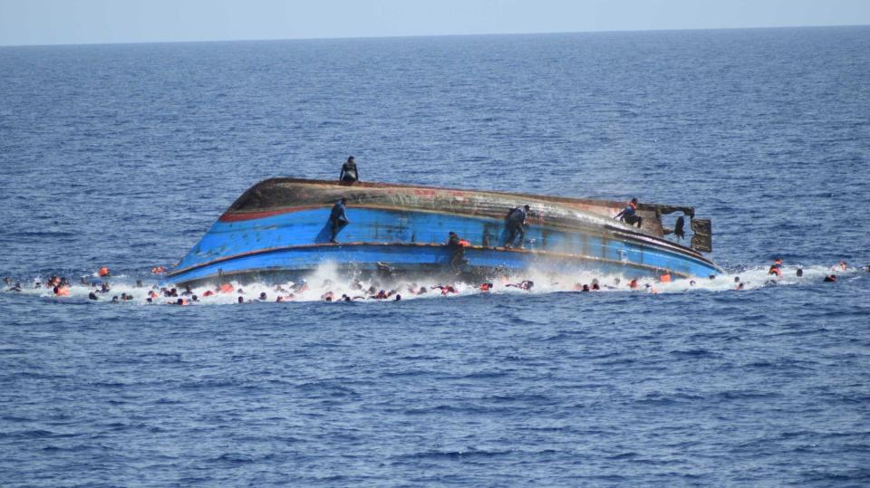 SICILIAN STRAIT, MEDITERRANEAN SEA - MAY 25: Migrants in a capsized boat are rescued by Bettica and Bergamini ships of Italian Navy at Sicilian Strait, between Libya and Italy, in Mediterranean sea on May 25, 2016. The Italian Navy saved around 500 migrants as they found dead bodies of seven migrants in the sea during the operations. (Photo by Italian Navy / Marina Militare/Anadolu Agency/Getty Images)