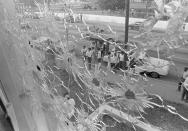 FILE - In this May 15, 1970, file photo, the bullet-riddled windows of Alexander Hall, a women's dormitory at Jackson State College in Jackson, Miss., are shown after two African-American students were killed and 12 injured when police opened fire on the building claiming they had seen a sniper. The historically black school canceled its 1970 graduation ceremony following the violence. Fifty-one years later, now named, Jackson State University is honoring the Class of 1970 back to salute their academic achievements with a graduation on Saturday, May 15, 2021. (AP Photo, File)