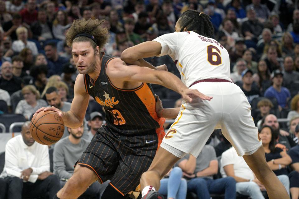 Orlando Magic center Robin Lopez (33) drives to the basket as Cleveland Cavaliers center Moses Brown (6) defends during the second half of an NBA basketball game, Tuesday, April 5, 2022, in Orlando, Fla. (AP Photo/Phelan M. Ebenhack)