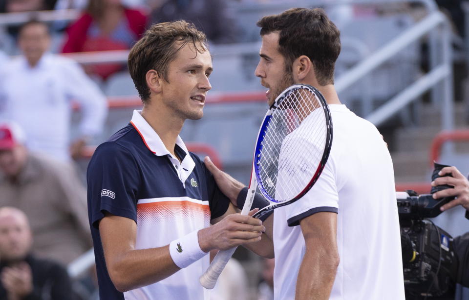 Karen Khachanov, right, of Russia congratulates compatriot Daniil Medvedev for the latter's victory during the Rogers Cup men’s tennis tournament semifinals Saturday, Aug. 10, 2019, in Montreal. (Paul Chiasson/The Canadian Press via AP)