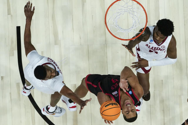 San Diego State forward Jaedon LeDee (13) shoots against Alabama forward Noah Gurley, left, in the first half of a Sweet 16 round college basketball game in the South Regional of the NCAA Tournament, Friday, March 24, 2023, in Louisville, Ky. (AP Photo/John Bazemore)