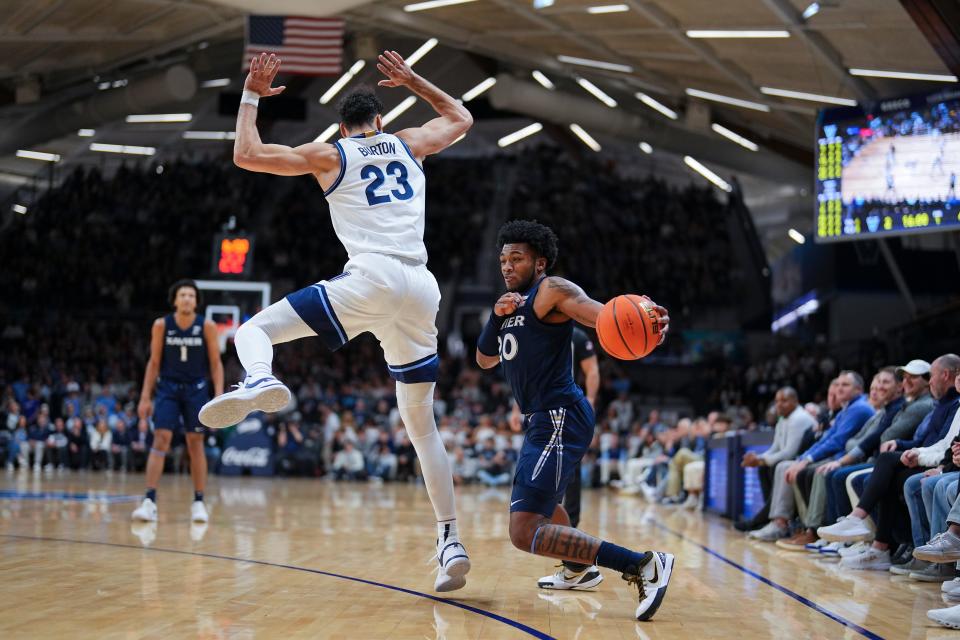 VILLANOVA, PENNSYLVANIA - JANUARY 3: Dayvion McKnight #20 of the Xavier Musketeers dribbles the ball around Tyler Burton #23 of the Villanova Wildcats in the first half at Finneran Pavilion on January 3, 2024 in Villanova, Pennsylvania.