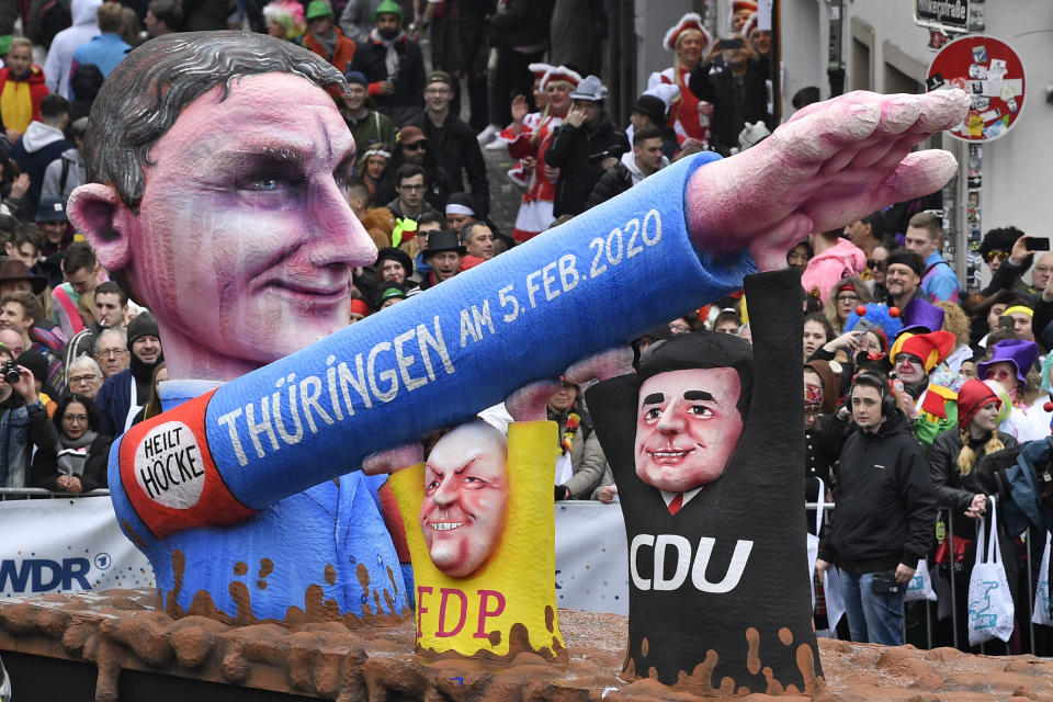 FILE - A carnival float, depicting far-right AfD politician Bjoern Hoecke, whose arm is raised by CDU and FDP politicians at the Thuringia elections, takes part the traditional carnival parade in Duesseldorf, Germany, Monday, Feb. 24, 2020. One of the most prominent figures in the far-right Alternative for Germany party is going on trial Thursday on charges of twice using a Nazi slogan, months before a regional election in which he is running to become his state’s governor. Bjoern Hoecke is the leader of the regional branch of Alternative for Germany, or AfD, in the eastern state of Thuringia. (AP Photo/Martin Meissner, File)