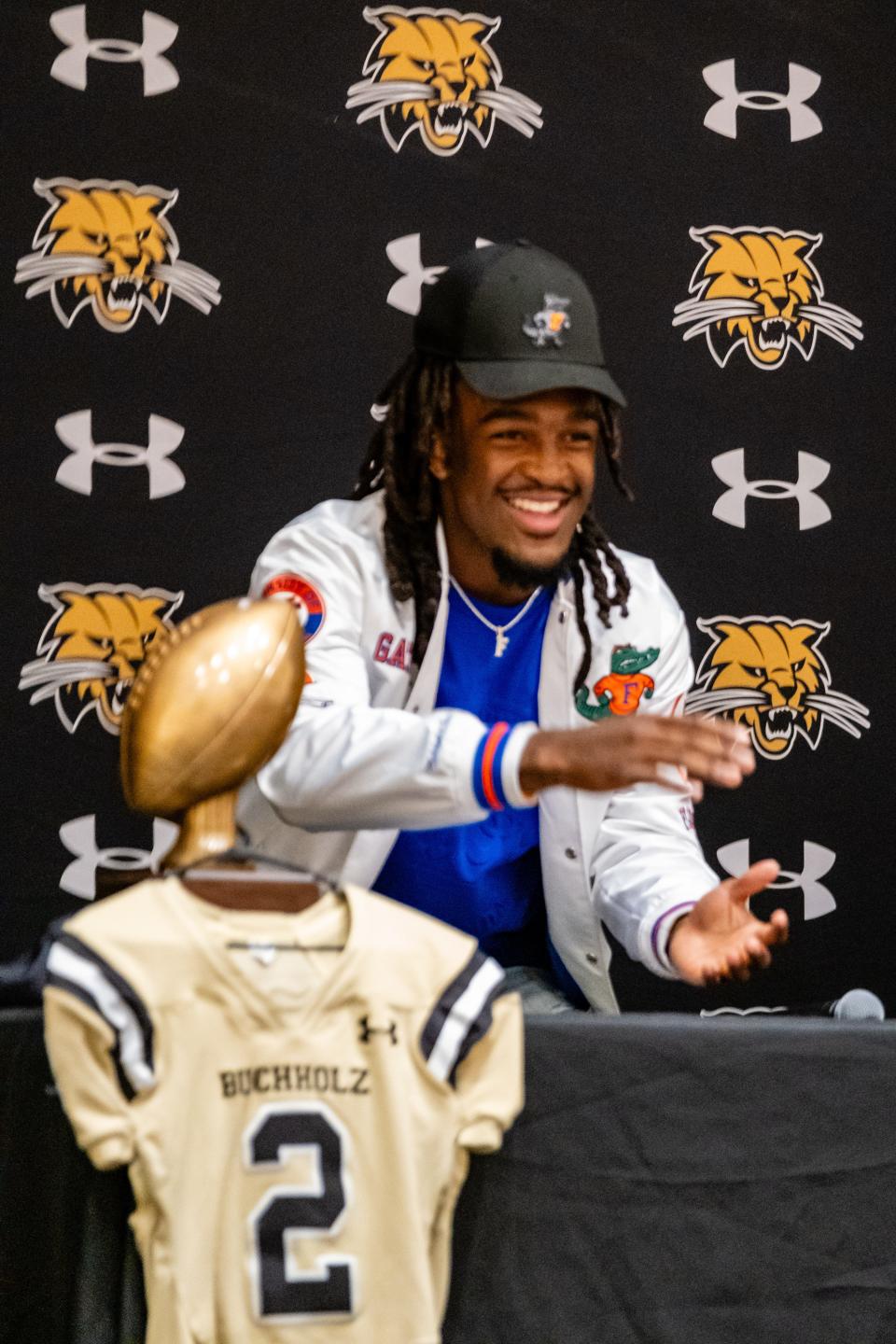 Myles Graham gestures to the audiance after sigining a letter of intent with the University of Florida at Buchholz High School in Gainesville, FL on Tuesday, December 19, 2023. [Chris Watkins/Gainesville Sun]