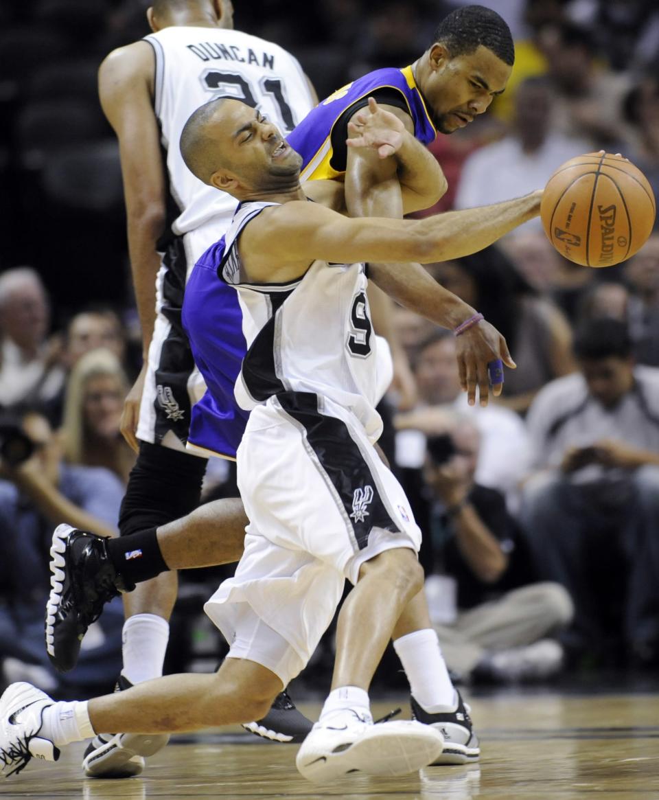 San Antonio Spurs guard Tony Parker, foreground, of France, is fouled by Los Angeles Lakers guard Ramon Sessions during the first half of an NBA basketball game on Friday, April 20, 2012, in San Antonio. (AP Photo/Bahram Mark Sobhani)