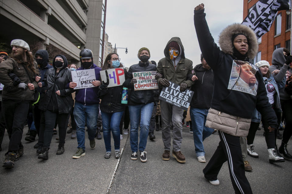 Protesters lock arms as they approach police lines during a march through downtown Grand Rapids, Mich., on Saturday, April 16, 2022. Activists have held protests for four straight days since the release of a video showing 26-year-old Congolese immigrant Patrick Lyoya being shot and killed by a Grand Rapids police officer while resisting arrest during a traffic stop on April 4. (Daniel Shular/The Grand Rapids Press via AP)