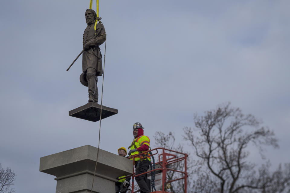 The bronze statue of Lieutenant General A.P. Hill is removed from its pedestal on Monday Dec. 12, 2022 in Richmond, Va. (AP Photo/John C. Clark)