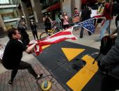 Protesters rip apart a U.S. flag during nationwide unrest following the death in Minneapolis police custody of George Floyd, in Raleigh