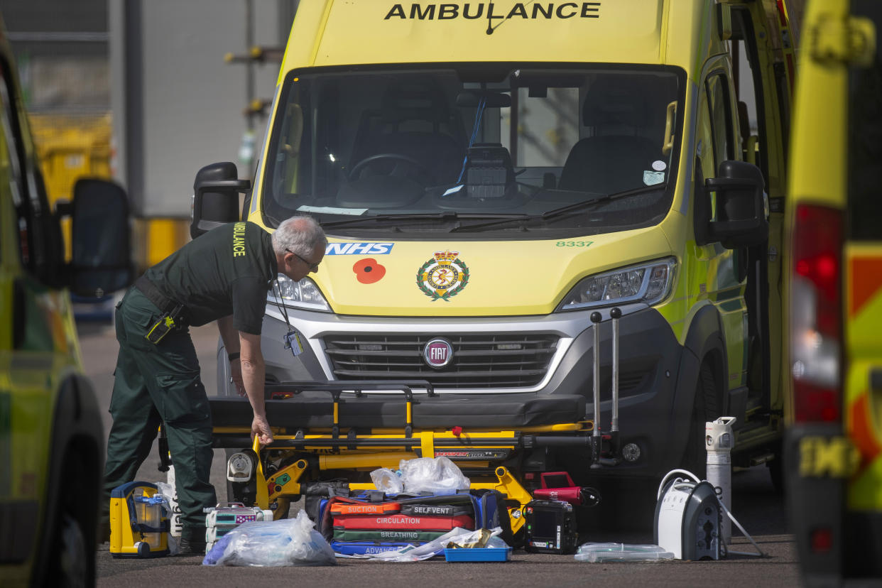 An NHS worker lays out breathing apparatus and equipment outside an ambulance outside the NHS Nightingale Hospital at the Excel Centre in London as the UK continues in lockdown to help curb the spread of the coronavirus.