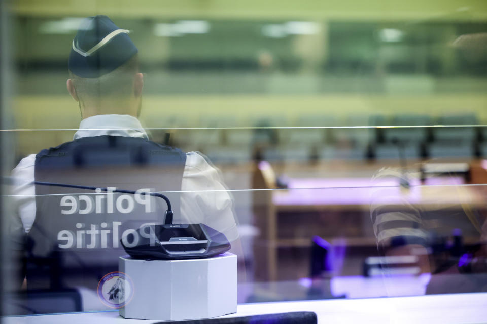 A police officer secures the courtroom at the start of the Brussels terrorist attack trial verdict in the Justitia building in Brussels, Tuesday, July 25, 2023. A jury is expected to render its verdict Tuesday over Belgium's deadliest peacetime attack. The suicide bombings at the Brussels airport and a busy subway station in 2016 killed 32 people in a wave of attacks in Europe claimed by the Islamic State group. (Olivier Matthys, Pool Photo via AP)