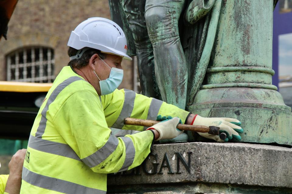 LONDON, ENGLAND - JUNE 09: Municipal workers remove the statue of slave-owner and slave merchant Robert Milligan after a petition in West India Quay district of London, United Kindgom on June 09, 2020. (Photo by Hasan Esen/Anadolu Agency via Getty Images)