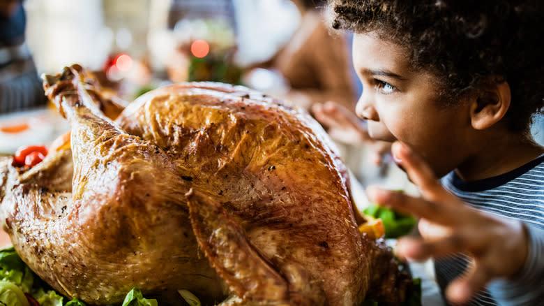 Roast turkey with child looking hungry