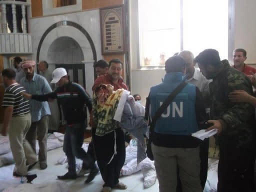 A picture released by the Syrian opposition's Shaam News Network shows UN observers at a hospital morgue in the central Syrian town of Houla on May 26. The UN Security Council held an emergency meeting Sunday on the situation in Syria, hearing that the toll from a massacre in the town of Houla had risen to 108 dead and 300 injured