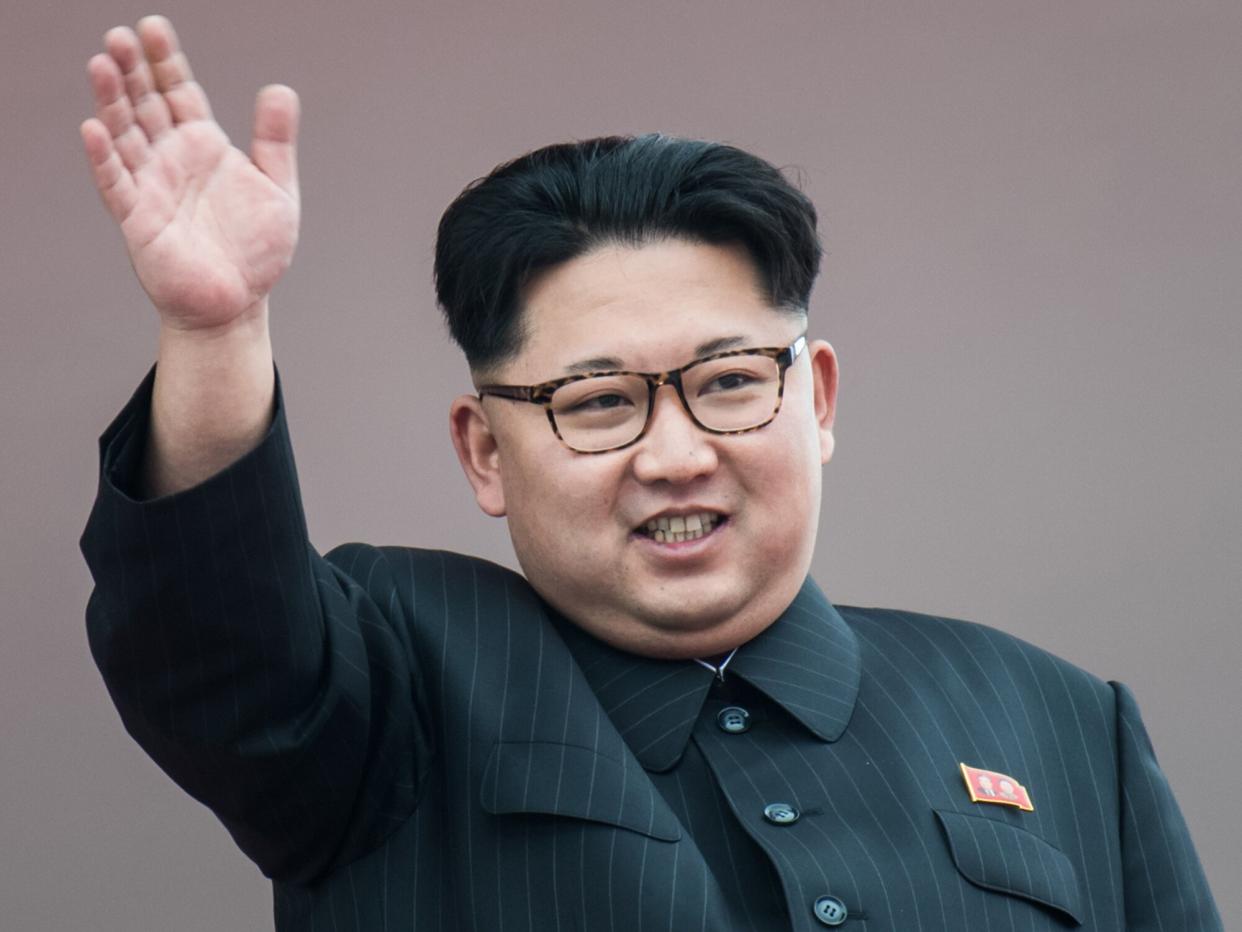 North Korean leader Kim Jong-Un waves from a balcony of the Grand People's Study House following a mass parade marking the end of the 7th Workers Party Congress in Kim Il-Sung Square in Pyongyang on May 10, 2016