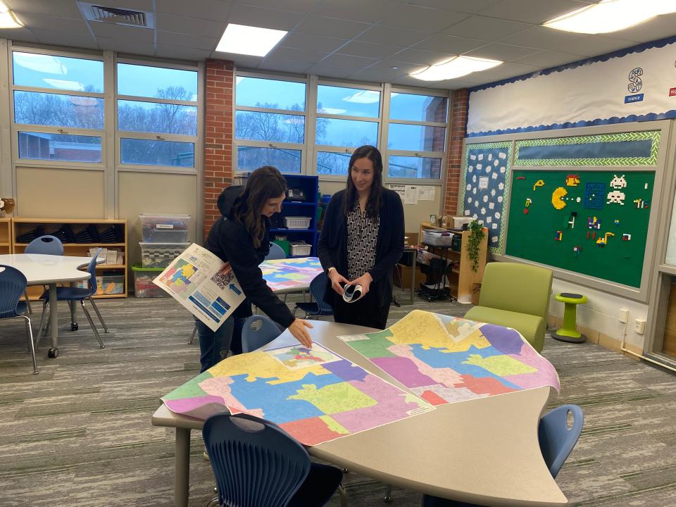 Parent Sarah Cox on Monday talks with Karen Jackson, with Columbia Public Schools contractor Woolpert, about options for boundary changes at Russell Boulevard Elementary School during an informational open house.