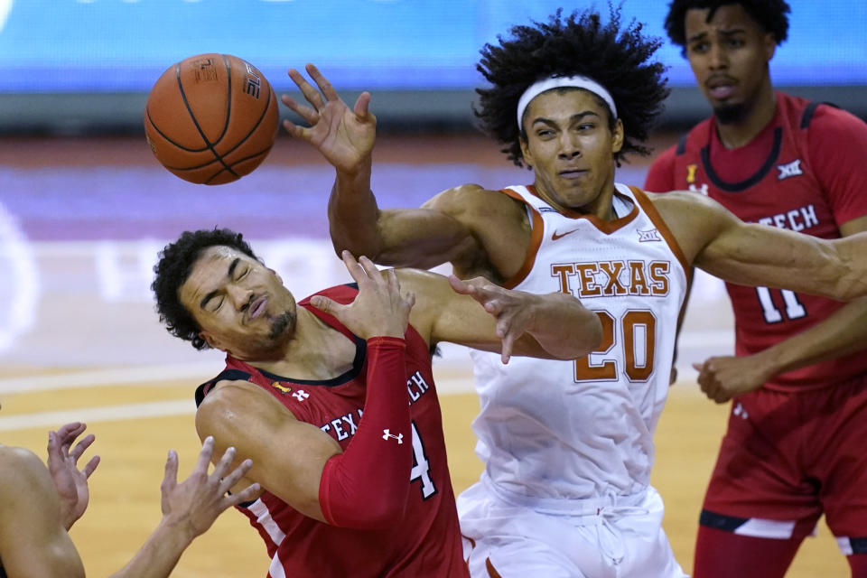 Texas Tech forward Marcus Santos-Silva (14) and Texas forward Jericho Sims (20) compete for a rebound during the first half of an NCAA college basketball game Wednesday, Jan. 13, 2021, in Austin, Texas. (AP Photo/Eric Gay)