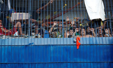 Detainees look out from a detention cell at a police station in Tondo, Manila, Philippines July 3, 2018. REUTERS/Erik De Castro/Files