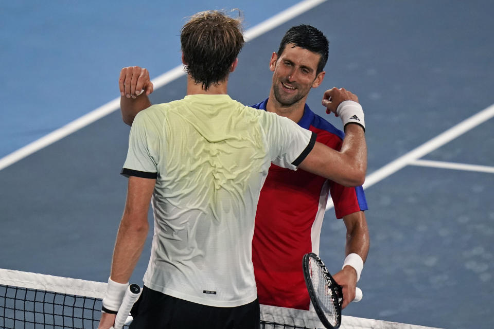 Alexander Zverev, of Germany, left, hugs Novak Djokovic, of Serbia, after defeating him during a semifinals match of the tennis competition at the 2020 Summer Olympics, Friday, July 30, 2021, in Tokyo, Japan. (AP Photo/Seth Wenig)