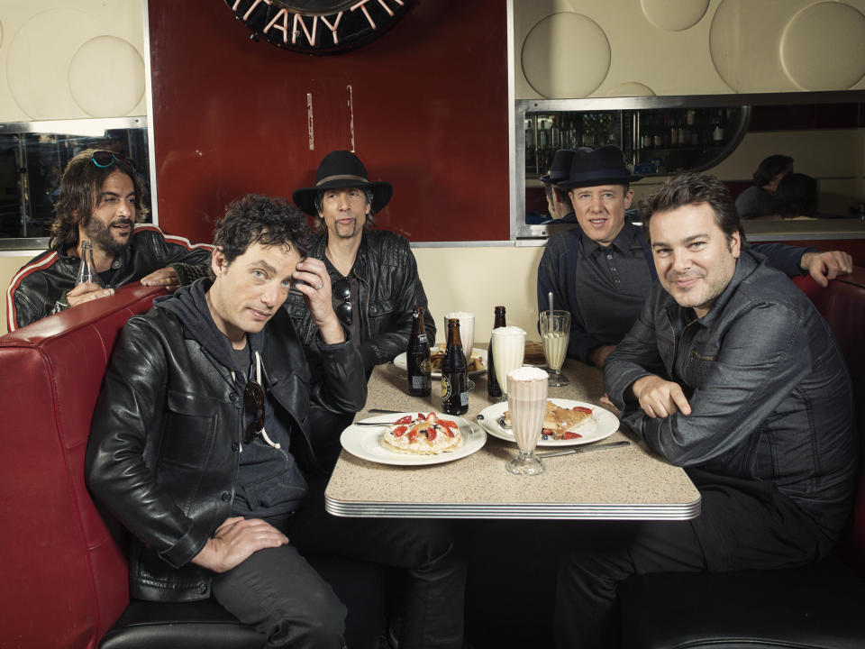 This Oct. 1, 2012 photo shows members of The Wallflowers, from left, Rami Jaffee, Jakob Dylan, Stuart Mathis, Jack Irons and Greg Richling posing for a portrait at The Meatpacking Diner in New York. The Wallflowers released a new album this month titled, "Glad All Over." (Photo by Victoria Will/Invision/AP Images)