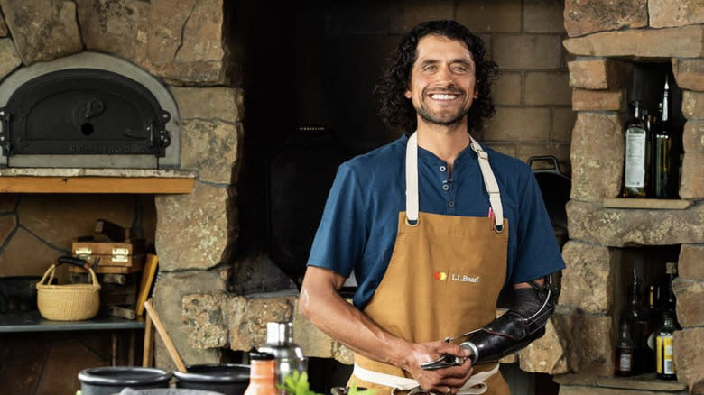 Chef Eduardo Garcia smiling in stone kitchen