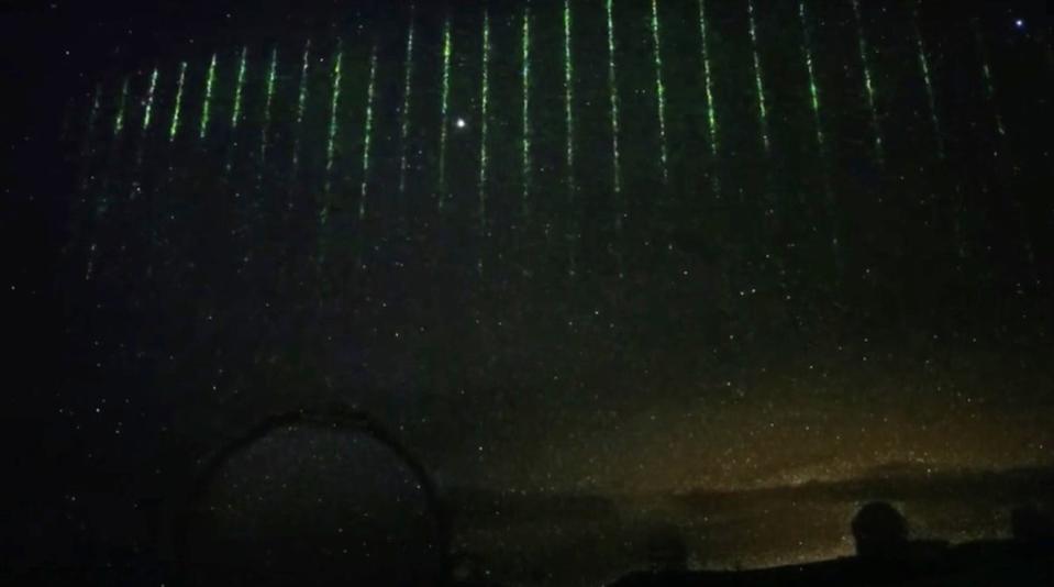 The green laser lights in the cloudy sky over Maunakea, Hawaii, on 28 January (NAOJ)