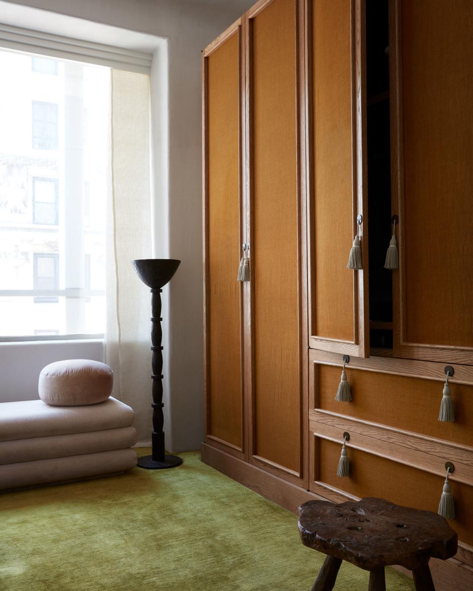 “This is enormous; it takes up the entire side of the room,” says Valle of the custom-made armoire in the master bedroom, which has an oak frame and linen panels covering the doors and drawers. The bronze floor lamp is by French sculptor Philippe Anthonioz, and the stool is a vintage piece from the Netherlands.