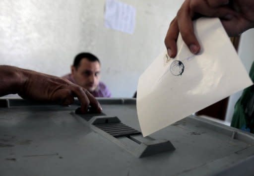 A Syrian voter casts his ballot for the parliamentary elections at a polling station in Damascus. Syrians voted on Monday in the country's first "multiparty" parliamentary election in five decades, held against a backdrop of violence and dismissed as a sham by the opposition