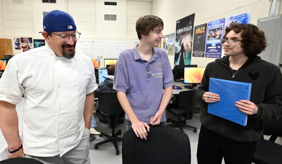 Co-directors Fernando Veraztigue, right, and Ian Wohlstadter, middle, talk with teacher Ernesto Sanchez about his voice-over part in a student film during the advanced animation class at Downey High School in Modesto, Calif., Thursday, April 4, 2024.