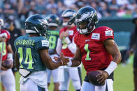 Philadelphia Eagles' Jalen Hurts, right, reacts with Kenneth Gainwell, left, during practice at NFL football training camp, Sunday, Aug. 7, 2022, in Philadelphia. (AP Photo/Chris Szagola)