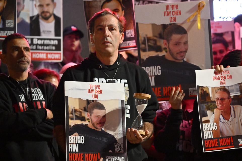 Ruby Chen, father of Israeli hostage Itay, held in Gaza since the Oct. 7 attack, lifts an hourglass as he delivers a statement to the media in Tel Aviv on Dec. 16, 2023.