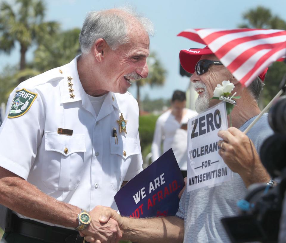 Volusia County Sheriff Mike Chitwood visits with counterprotesters, Saturday, April 22, 2023, at Granada Boulevard and Beach Street in front of Ormond Beach City Hall.